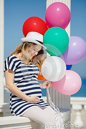 Portrait of pregnant woman with sunglasses and hat Stock Photo