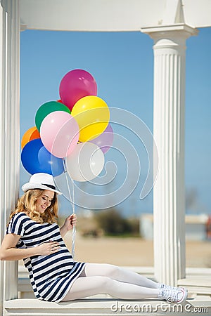 Portrait of pregnant woman with sunglasses and hat Stock Photo