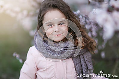 Portrait of a preschool girl in autumn in warm clothes and a scarf Stock Photo