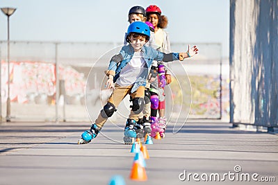 Happy inline skater practicing slalom skating Stock Photo