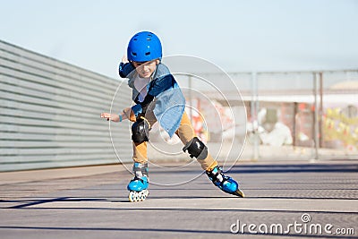 Boy riding on roller skates at outdoor skate park Stock Photo