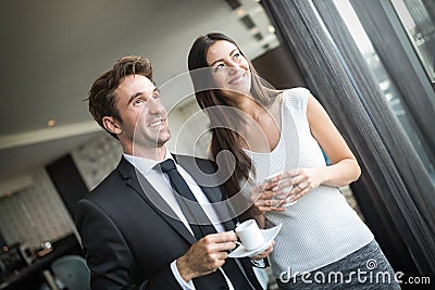 Portrait of pretty businesswoman drinking coffee, talking to male colleague Stock Photo