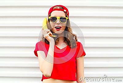 Portrait pretty cool woman with banana having fun over white Stock Photo