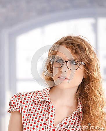 Portrait of pretty girl front of window in glasses Stock Photo