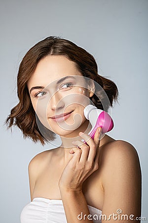 Positive delighted female person washing her face Stock Photo