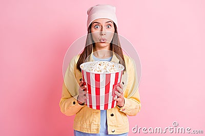 Portrait of pretty lady hands holding popcorn unexpected scary moment headwear cap isolated on pink color background Stock Photo