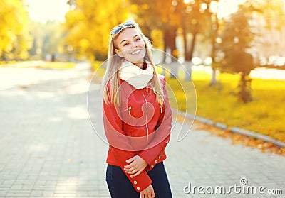 Portrait pretty smiling young woman in sunny autumn Stock Photo