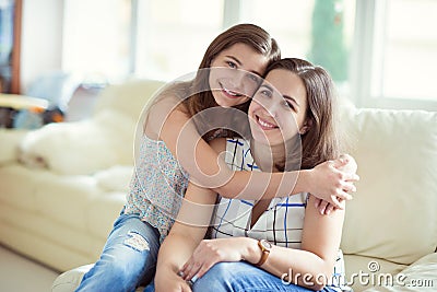 Portrait of pretty young mother with her tennager daughter Stock Photo