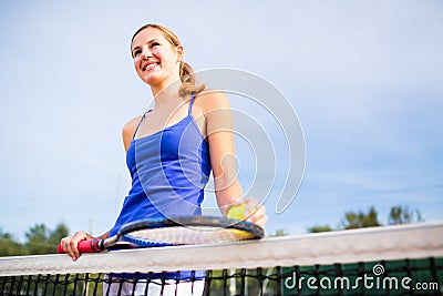 Portrait of a pretty, young tennis player on a court Stock Photo