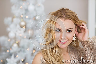 Portrait of pretty young woman smiles and touches her long hair Stock Photo