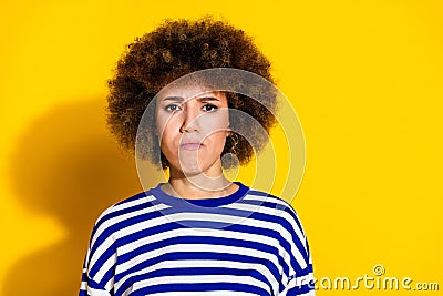 Portrait of pretty young woman sullen face empty space wear striped shirt isolated on yellow color background Stock Photo