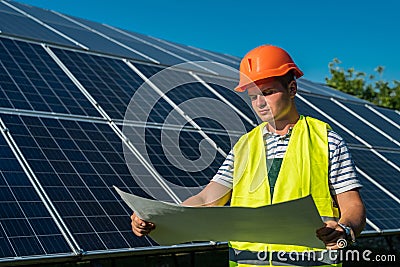 Portrait of professional electrician helmet on solar panel station Stock Photo