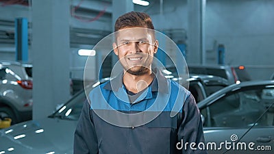 Portrait of Professional smiling car mechanic working in modern auto repair service Stock Photo