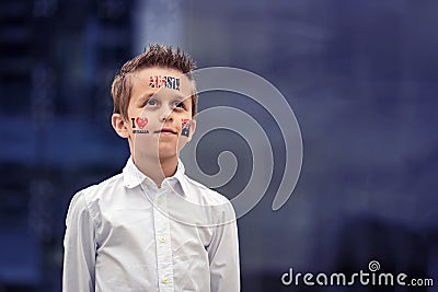 Portrait of proud Aussie boy with flag themed tattoos on Australia Day Stock Photo