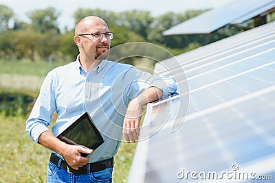 The portrait of a proud engineer smiles satisfied with his successful work. Concept: renewable energy, technology Stock Photo