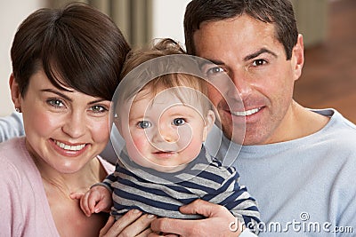 Portrait Of Proud Parents With Baby Son At Home Stock Photo