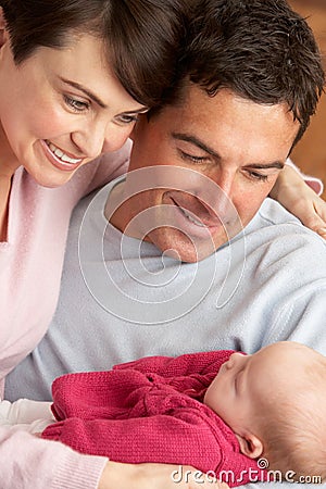 Portrait Of Proud Parents With Newborn Baby Stock Photo