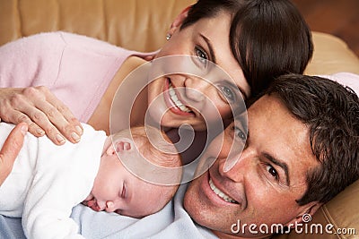 Portrait Of Proud Parents With Newborn Baby Stock Photo