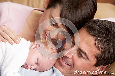 Portrait Of Proud Parents With Newborn Baby Stock Photo