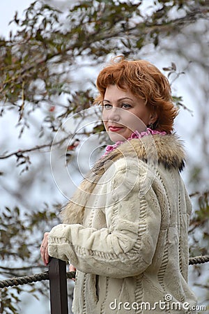 Portrait of the proud woman of average years in a light short fur coat Stock Photo