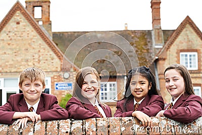 Portrait Of Pupils In Uniform Outside School Building Stock Photo