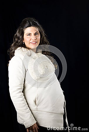 Portrait of radiantly pregnant woman in winter clothes Stock Photo