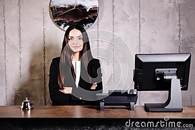 Portrait of receptionist at desk in lobby. Banner design. Friendly concierge at hotel reception behind the counter Stock Photo