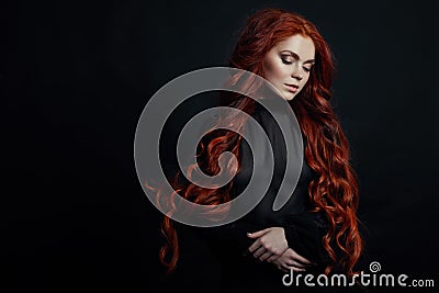 Portrait of redhead woman with long hair on black background. Perfect girl with the blue eyes, nice clean skin Stock Photo