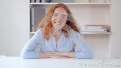 Portrait redheaded lady at working place. Stock Photo