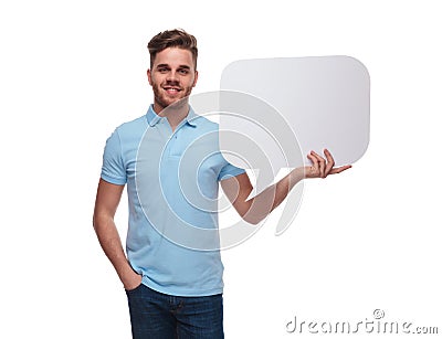 Portrait of relaxed man wearing polo shirt holding speech bubble Stock Photo