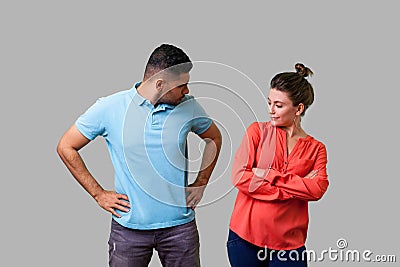 Portrait of resentful dissatisfied couple in casual wear standing together. isolated on gray background Stock Photo