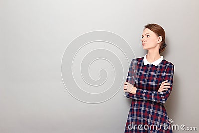 Portrait of resentful girl with head turned away, holding arms folded Stock Photo