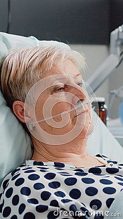 Portrait of retired woman with sickness laying in bed Stock Photo