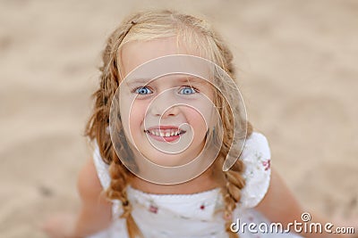 Portrait risible blonde girl with pigtails and blue round eyes Stock Photo