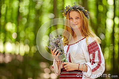 Girl in traditional costume in the forest Stock Photo