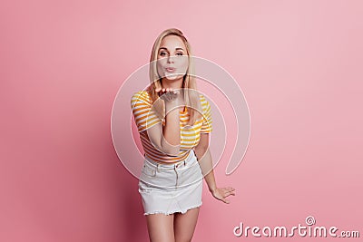 Portrait of romantic lovely lady send air kiss on pink background Stock Photo