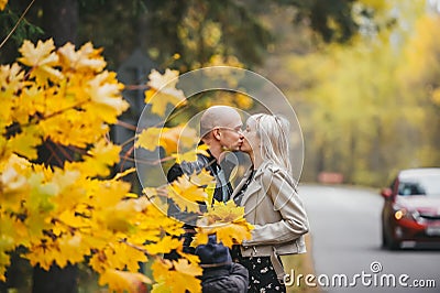 Portrait of romantic young couple in autumn landscape near road Stock Photo