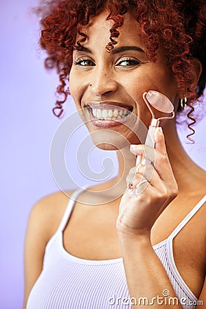 Portrait, rose quartz and woman in studio for skincare, anti aging or collagen circulation on purple background. Face Stock Photo