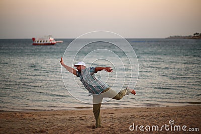 Portrait of a running caucasian man in a hurry on the sunset beach Stock Photo