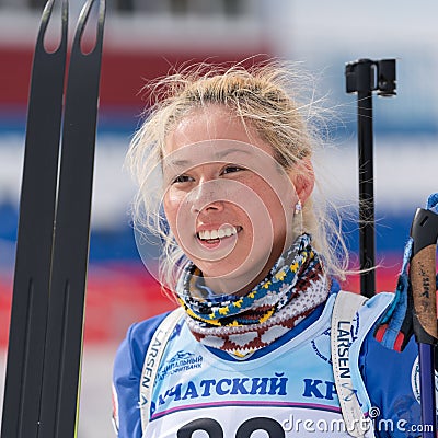 Portrait Russian sportswoman biathlete Kseniya Petrunova (Kamchatka) at finish after skiing and rifle shooting Editorial Stock Photo