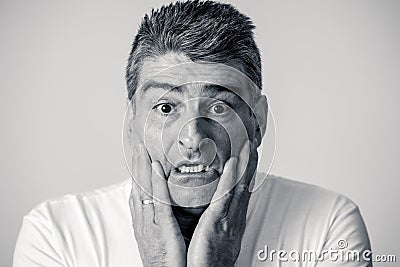 Portrait of a 40s 50s man in shock with a scared expression on his face making frightened gestures in human emotions feelings and Stock Photo
