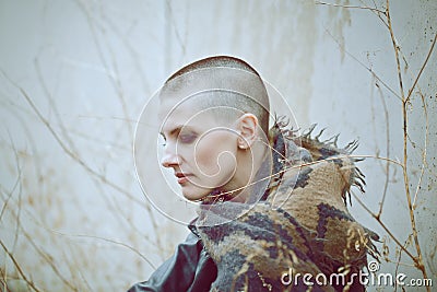 Portrait of sad beautiful Caucasian white young bald girl woman with shaved hair head in leather jacket and scarf Stock Photo