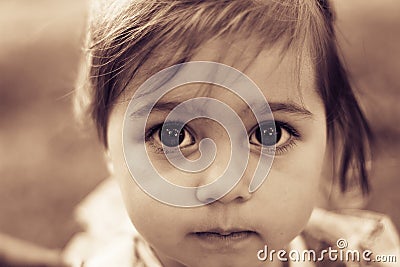 Portrait of a sad liitle girl close-up. Toned Stock Photo