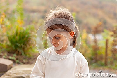 Portrait of a sad little girl in a white T-shirt Stock Photo