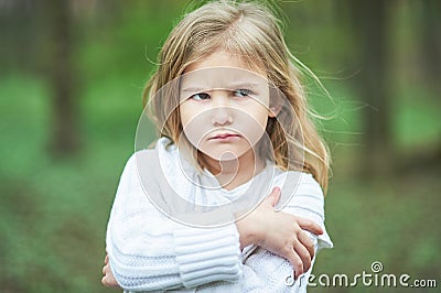 Portrait of sad unhappy little girl. Little sad child is lonesome. upset and distraught angry facial expression. Stock Photo