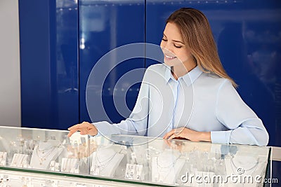 Portrait of saleswoman near showcase in jewelry store Stock Photo