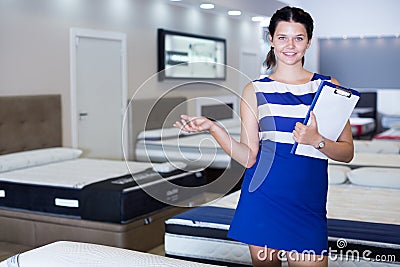 Portrait of saleswoman who is standing with price on her workplace Stock Photo