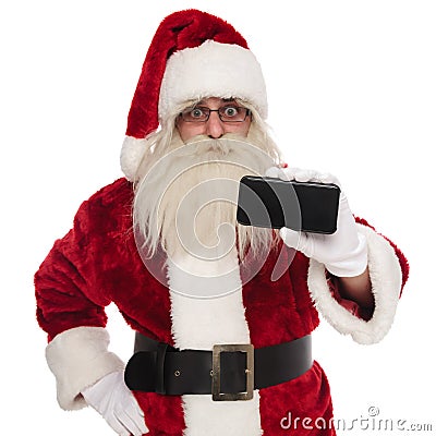 Portrait of santa claus presenting blank telephone screen Stock Photo