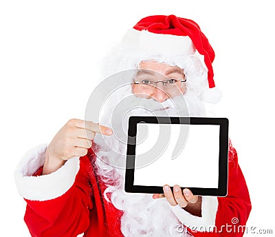 Portrait of santa pointing at digital tablet Stock Photo