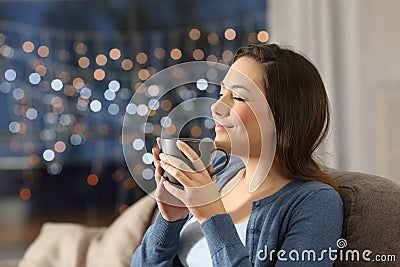 Woman relaxing drinking coffee in the night at home Stock Photo